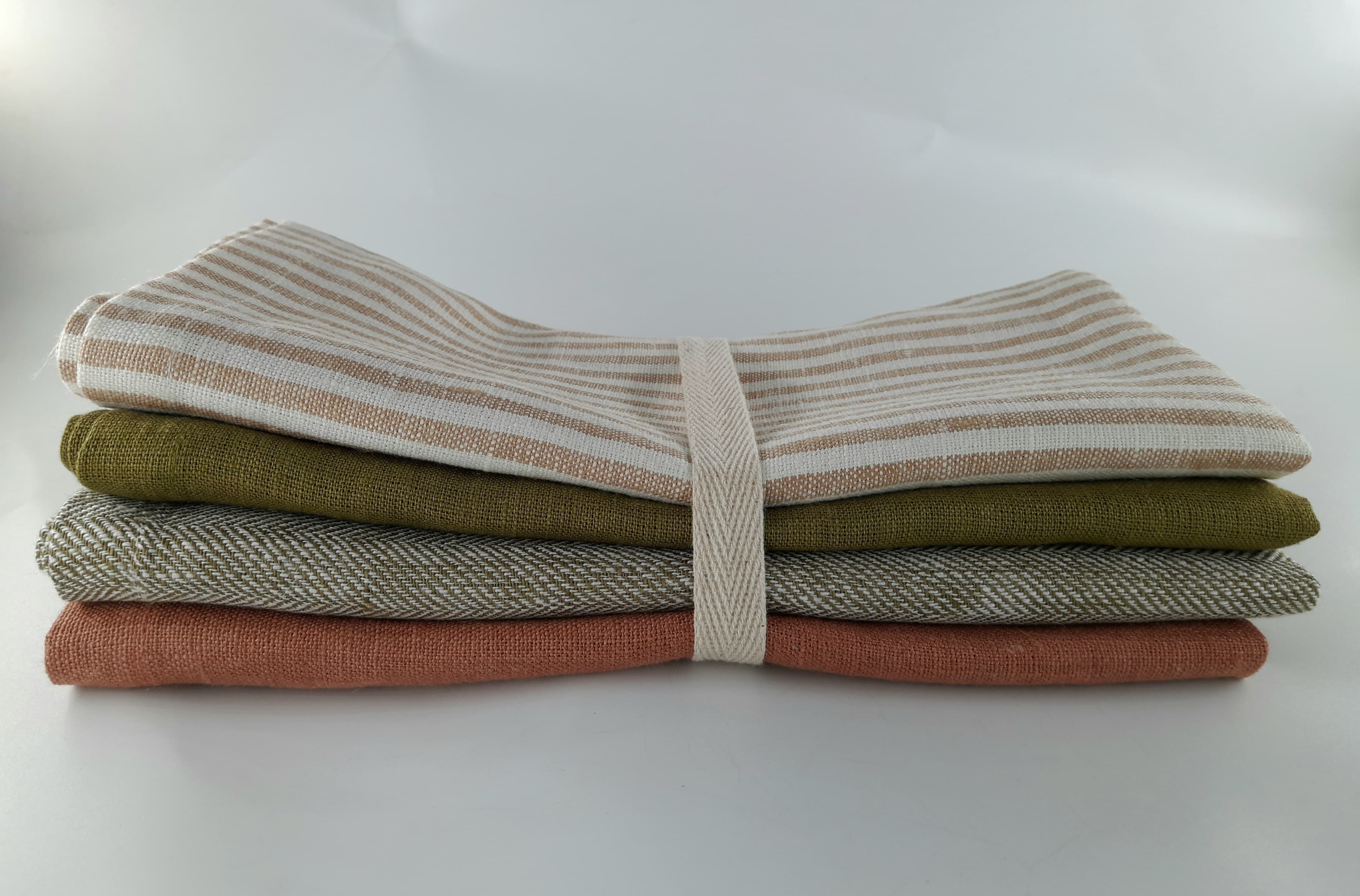 Stack of folded European-flax linen napkins tied with twill tape