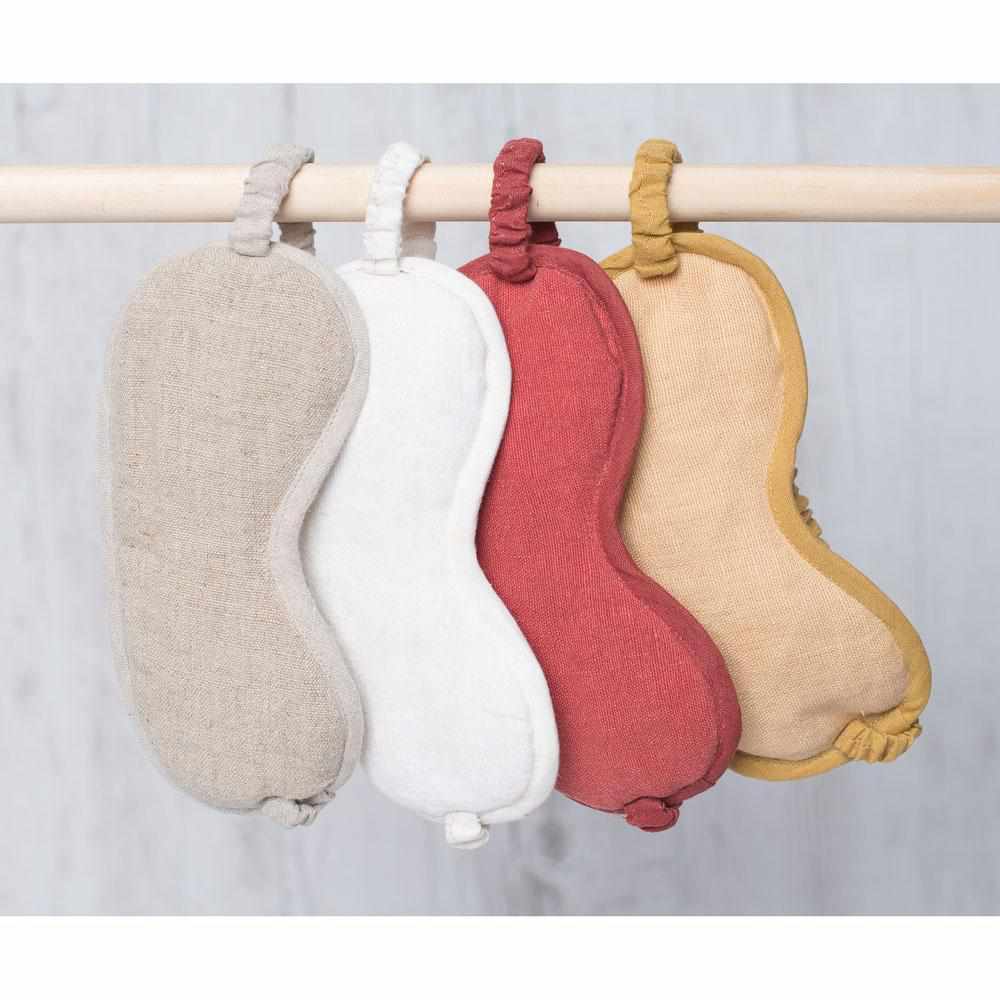 Assorted scalloped linen pieces hanging on a rail