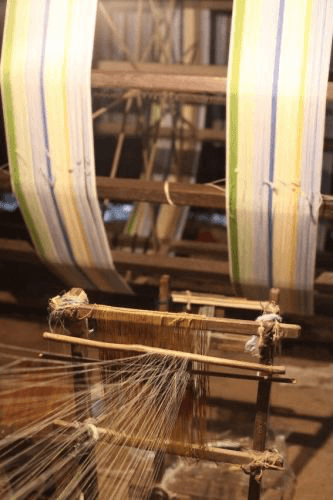 Traditional handloom weaving striped fabric in Bhagalpur