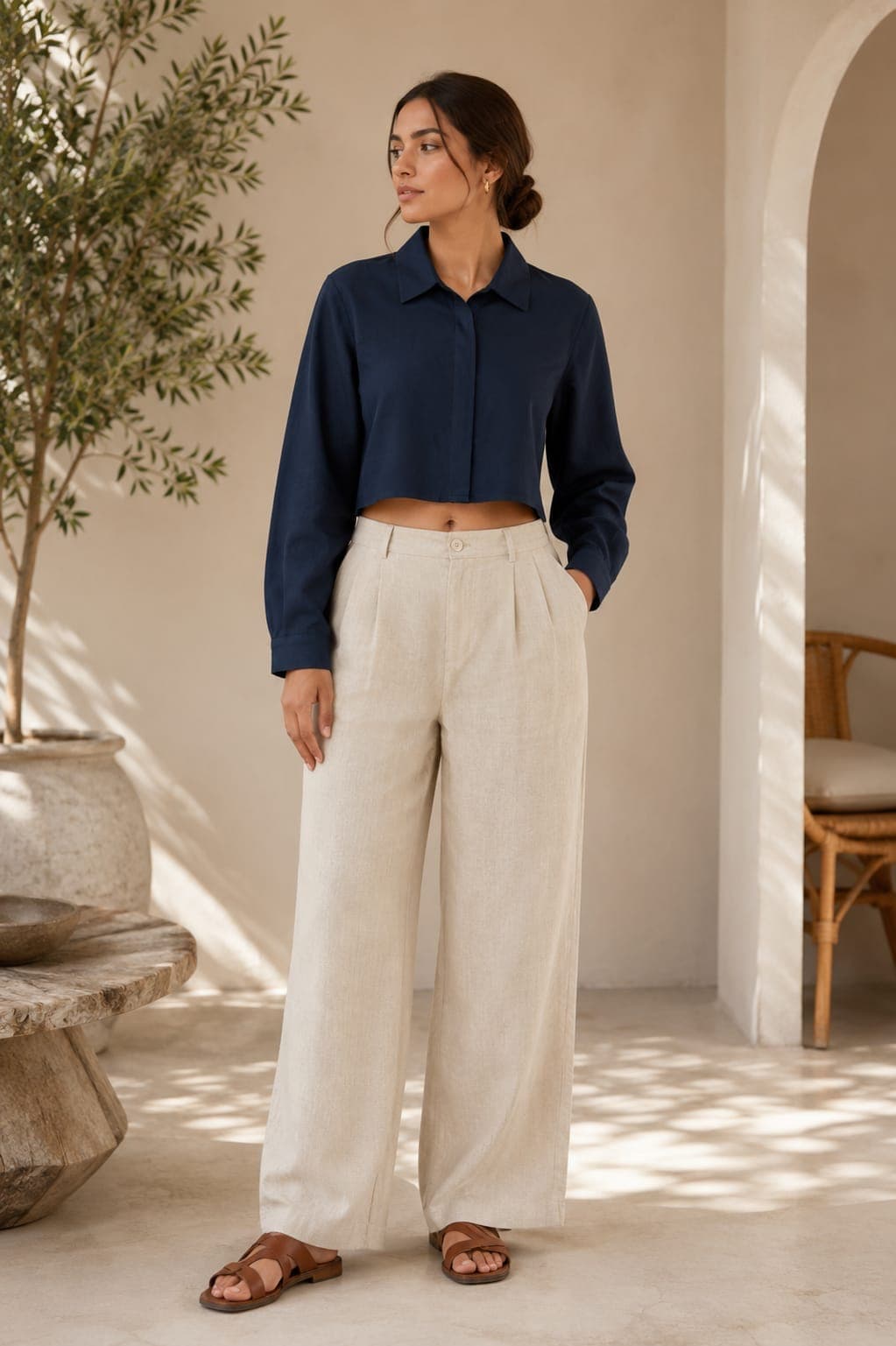 Model in a navy linen cropped shirt and oatmeal wide-leg trousers