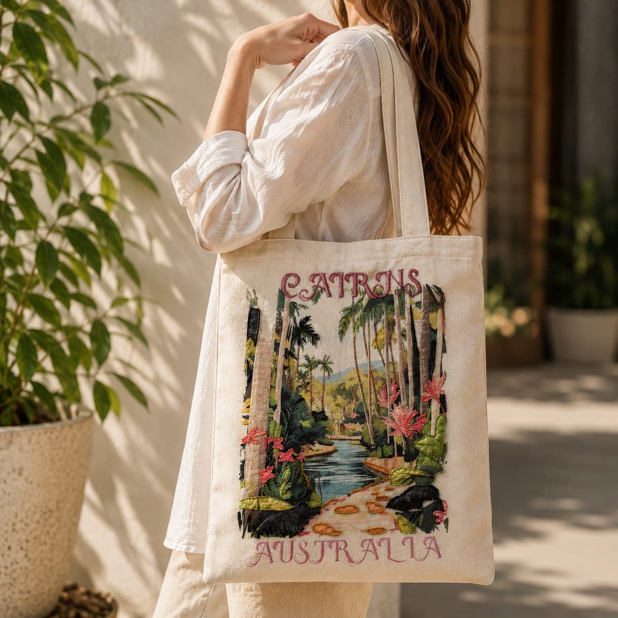 Embroidered Cairns Australia linen tote worn over a white linen shirt