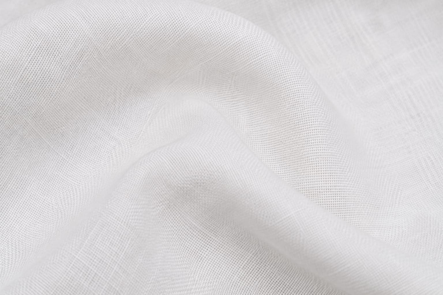 Close-up of white linen fabric showing the natural weave