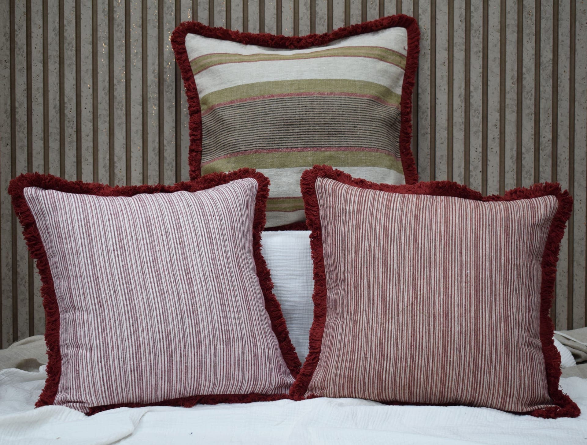 Striped linen cushions with frayed burgundy borders