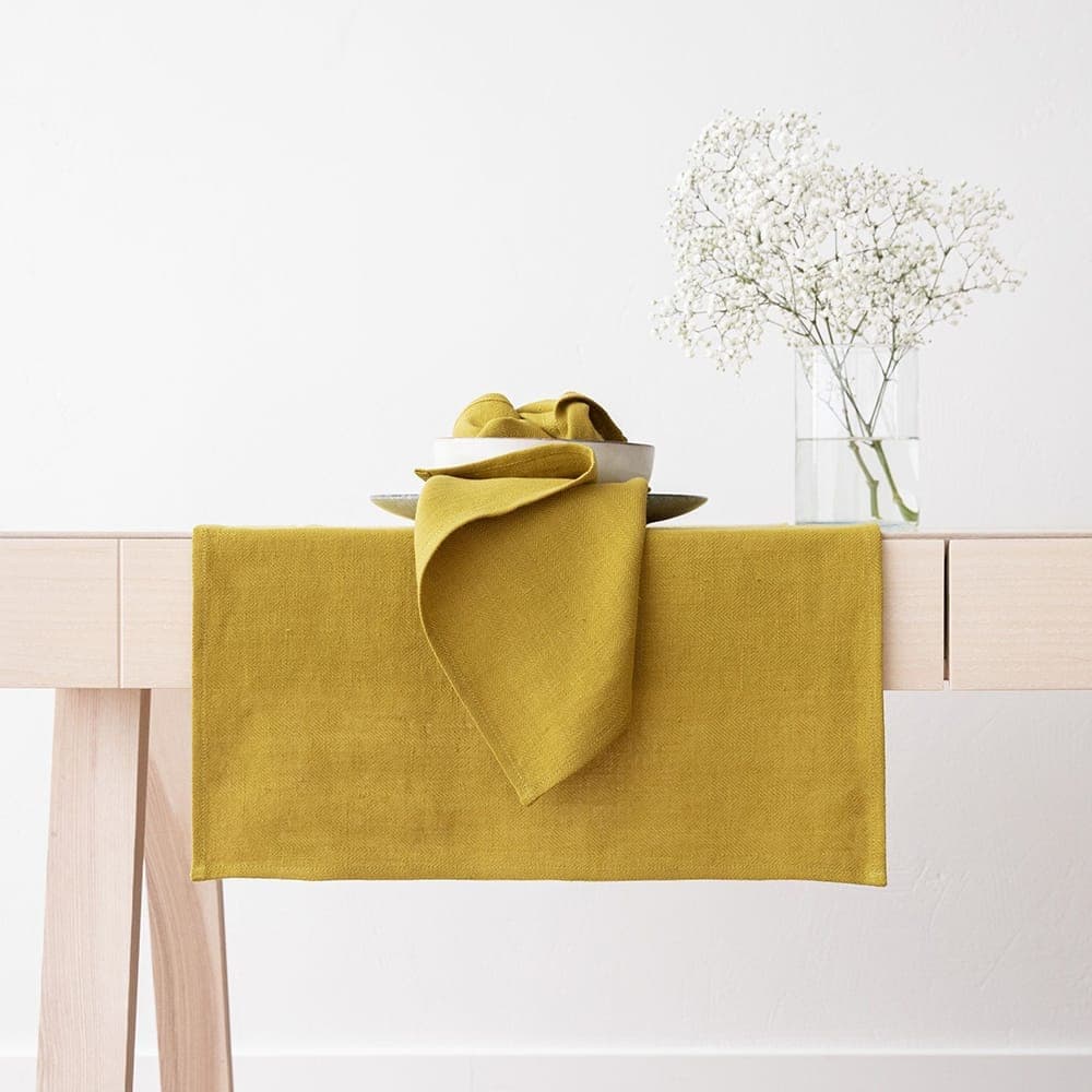 Mustard linen table runner and napkin with white flowers